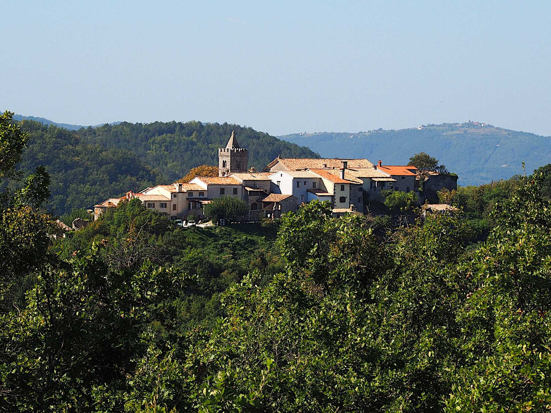 Le bourg de Hum, ses maisons de pierre et son clocher, sur une colline boisée de l'intérieur de l'Istrie